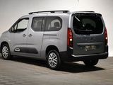 the silver van is parked in a large room with a checkered floor