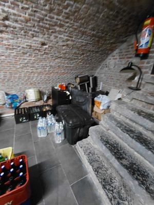 a room with a lot of bottles of water on the floor