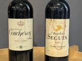 two bottles of wine sitting on a wooden table