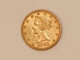 a close up of a gold coin with a woman ' s head on it