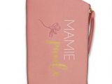 the pink purse has a name on it and a gold zipper around it