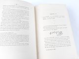 an open book with writing on it on a table