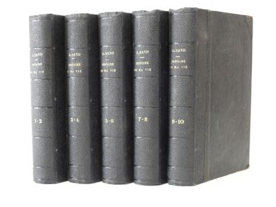 four books are lined up in a row on a white surface