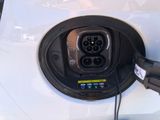 an electric car plugged in to a charging station with a charger