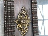a wooden clock that is hanging on the wall