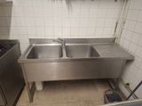 a stainless steel sink in the middle of a kitchen