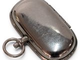 a silver case that has a key in it