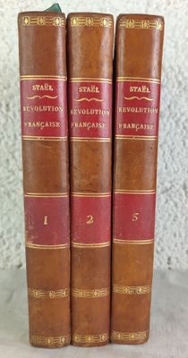 three books sitting on top of each other on a table