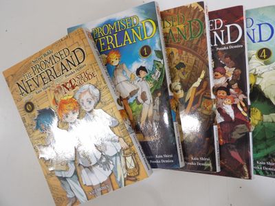 four children ' s books are lined up on a white surface