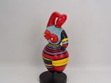 a small figurine of a rooster on a stand
