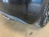 a close up of a car ' s bumper with a sticker on it