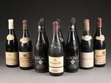 several bottles of wine are lined up in a row on a table