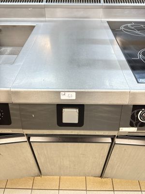 a stainless steel stove top with two burners on it