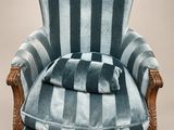 une photo d'une chaise à rayures bleues sur laquelle est posé un coussin
