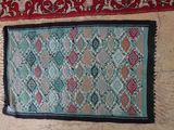 two rugs on a wall with different colors and patterns on them