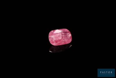 a pink diamond on a black background