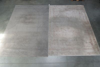 two rugs that are on the floor in the room