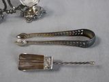 two silver spoons and a fork on a table