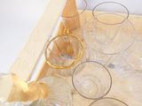 un plateau sur lequel se trouvent des verres et une bouteille de vin