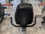 a row of stationary exercise bikes in a gym