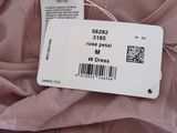 the label on a pink dress is attached to the back of the dress