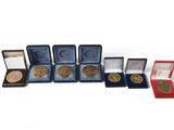 several medals and medals are lined up in a row on a white surface