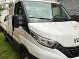 a white truck that is parked in the grass
