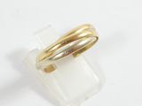 a close up of a gold ring on a white surface