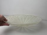 a person holding a glass bowl on a white table