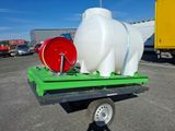 a large water tank on a trailer with a hose attached to it