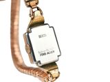 a watch that is attached to a gold bracelet