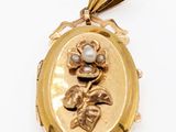 a close up of a gold locke with a flower on it