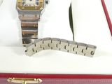 a box with a watch and a pen in it