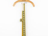 an image of a wooden coat hanger with a green and white design