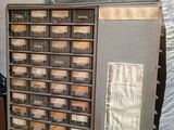 a machine that has many drawers on it in a room