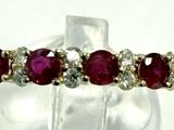 an image of a close up of a ring with red stones on it