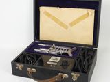 a black suitcase with a silver pipe in it