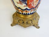 a vase that is sitting on a stand on a white surface