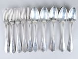 a lot of spoons and forks on the table