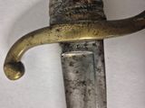 a close up of a knife on a white surface