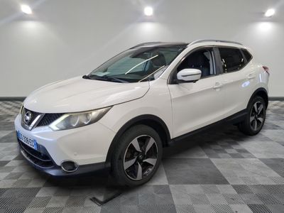 a white nissan suv parked on a checkered floor in a garage
