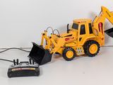 a toy bulldozer with a remote control on the table