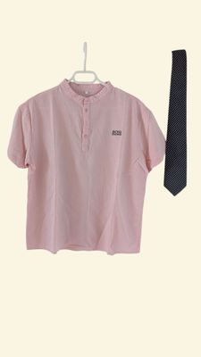 a pink shirt and a black tie hanging on a hanger