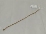 a close up of a gold chain with a tag attached to it