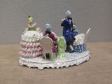 a figurine of a man and a woman sitting on a table