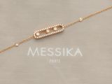 a close up of a gold bracelet with diamonds on it