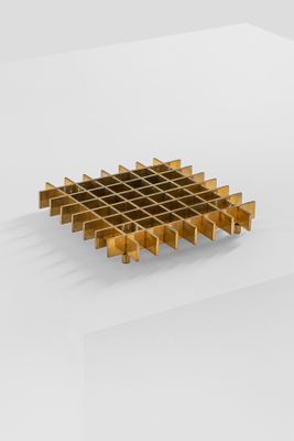 a close up of a metal grid on a white surface
