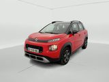 a red citrole is parked in a white room