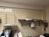 a picture of a kitchen with a lot of clutter on the counter