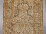 an antique persian rug with a gold border and a white background